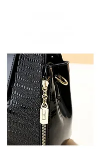 Detailed macro of black crocodile texture leather with premium gold metal zipper hardware