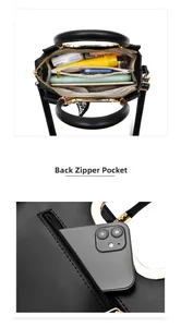 Detailed interior view of a black leather handbag with gold hardware and multiple compartments
