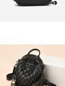 Detail of black quilted leather backpack showing reinforced handle and metal zippers