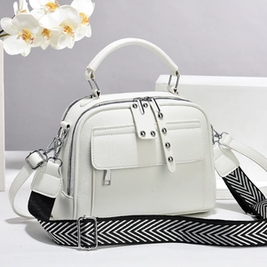White pebbled leather handbag with wide herringbone strap and silver hardware accents