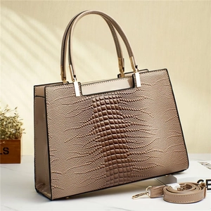 Glossy apricot patent leather tote bag with crocodile texture and gold hardware