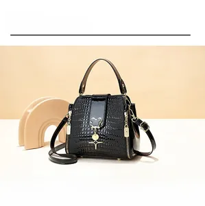 Detailed view of black crocodile pattern bucket bag with golden Mickey silhouette accent