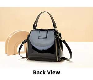 Back view of black patent leather bucket bag with glossy finish and gold zipper details