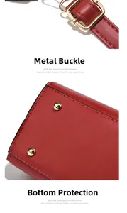 Detail of red leather handbag with gold metal hardware buckle and bottom protective studs