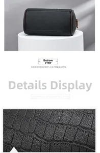 Detail of the flat bottom and crocodile-embossed leather texture of the black barrel bag