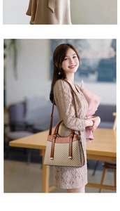 Close-up of elegant beige geometric canvas handbag with premium brown leather trim and handles