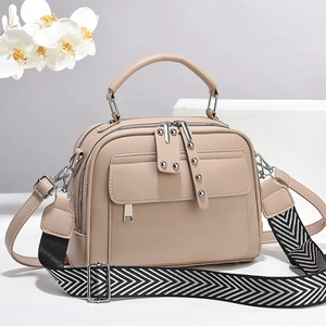 Beige faux leather multi-layer handbag with wide geometric strap and metal rivets