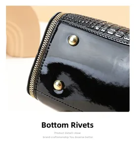 Detail of black patent leather bucket bag with quilted texture and gold metal studs