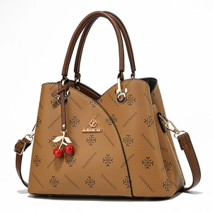 Brown leather handbag with JANENOVO monogram pattern and a decorative cherry charm