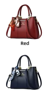 Close-up of red and navy leather handbags with logo and silk scarf on handles