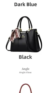 Close-up of black faux leather handbag with gold logo detail and silk scarf accessory