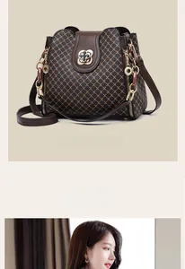 Detail of dark brown monogram bucket bag with gold flower lock and side zipper