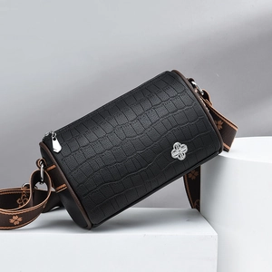 Black crocodile embossed cylinder bag with clover logo and floral jacquard strap