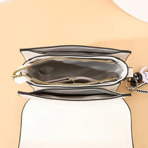Chic beige crossbody bag with multi-layer interior and gold zipper shown from above