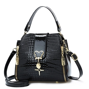 Glossy black crocodile embossed bucket bag with golden mouse pendant and shoulder strap