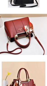 Detail of burgundy tote with gold logo, adjustable strap and printed silk scarf accessory