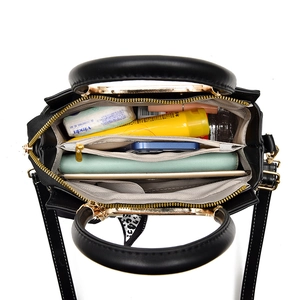 Spacious black PU leather handbag with multi-compartment interior and gold hardware