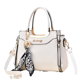 Chic beige quilted handbag with gold hardware and leopard print scarf accessory