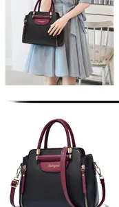 Détail d'un sac à main en cuir bicolore avec texture lychee et fermoir doré chic