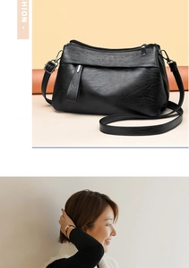 Detail of classic black lychee texture leather shoulder bag with adjustable strap