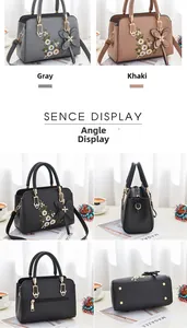 Detail view of large capacity embroidered soft leather handbag with bow charm and floral patterns