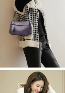 Close-up of high-quality purple leather texture and elegant silver hardware on the bag