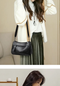 Close-up of retro black soft leather shoulder bag with vintage texture and silver zippers