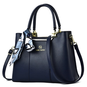 Elegant navy synthetic leather handbag with scarf detail and adjustable strap