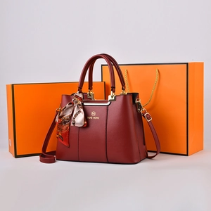 Elegant wine red leather tote bag for women with floral scarf and golden hardware detail