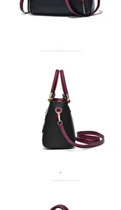 Détails du sac à main en cuir bicolore noir et bordeaux avec finitions dorées chic