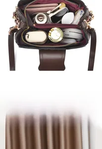 Detail of the multi-compartment interior space in this dark brown monogram handbag