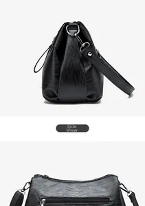 Side view detail of black soft leather handbag showing smooth texture and back zipper