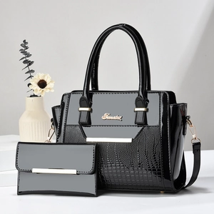 Glossy black patent leather tote with crocodile texture and matching clutch handbag set