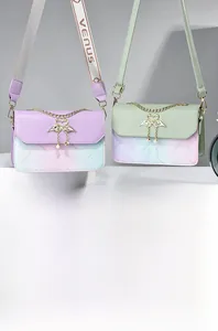 Detail of elegant swan metal clasp with pearl tassels on a gradient floral handbag