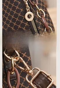 Detail of premium golden hardware and smooth zipper on a vintage textured crossbody bag