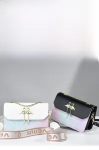 Detail of elegant contrast shoulder bag with golden swan clasp and Venus printed strap