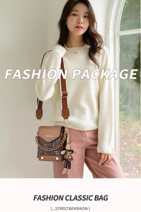 Detail of crossbody bag with letter print texture, metal chain, and cute rabbit charm