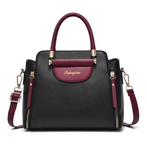 Sac à main élégant bicolore en cuir noir et bordeaux avec bandoulière réglable incluse