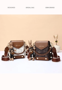 Detail of small crossbody phone bags with wide straps and cute rabbit pendants