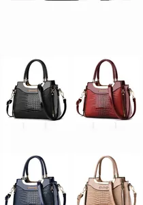 Detail showing faux leather handbags with patent crocodile texture in four classic colors