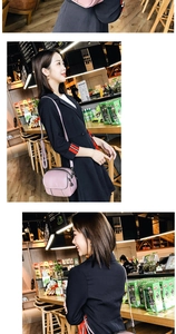 Detail view of pink soft leather crossbody bag with multiple zippers and long strap