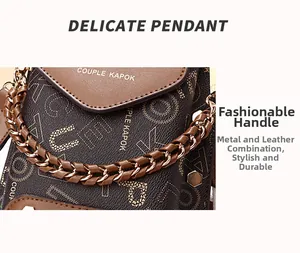 Detail of crossbody phone bag showing woven chain strap and letter embossed leather finish