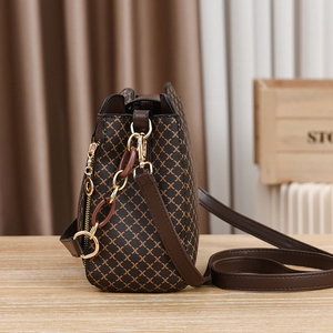 Retro brown crossbody bag with geometric patterns and golden chain strap on table