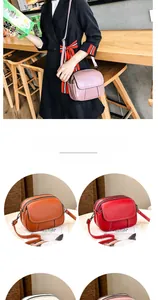 Detailed view of multi-compartment leather crossbody bag with lychee grain texture