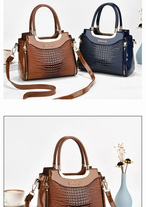 Detail of glossy patent leather handbag with crocodile pattern texture and metal handles