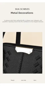 Detail of black textured leather handbag with gold metal trim and quilted embroidery
