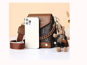 Mini crossbody bag with monogram pattern, wide strap, and cute knit rabbit charm