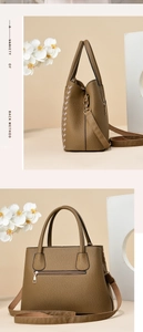 Detail view of khaki leather tote with embroidery patterns and adjustable strap