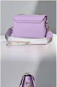 Detail view of the lavender crossbody bag showing stitching and wide woven strap