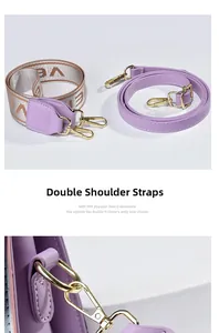 Detail view of purple handbag shoulder straps with golden metal lobster clasps